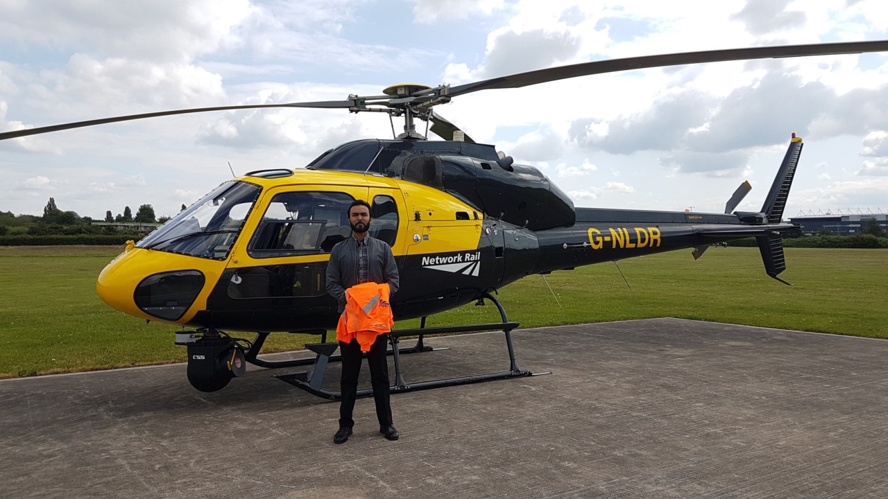 Danial Standing in front of a helicopter